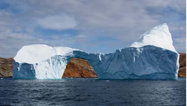 CC by Kim Hansen; Iceberg with a hole in the strait between Langø and Sanderson Hope south of Upernavik, Greenland.s_Hope_2007-07-28_2.jpg